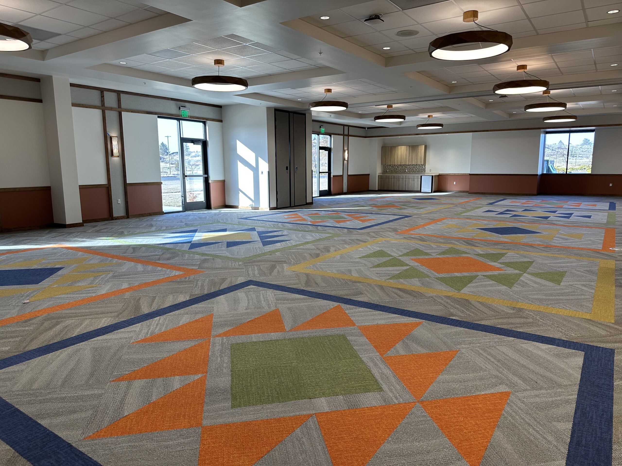Klamath Tribal Health and Family Services at New Way featuring carpet tiles in a custom tribal design. Flooring by Cardinal Flooring and Supply in Medford and Klamath Falls.